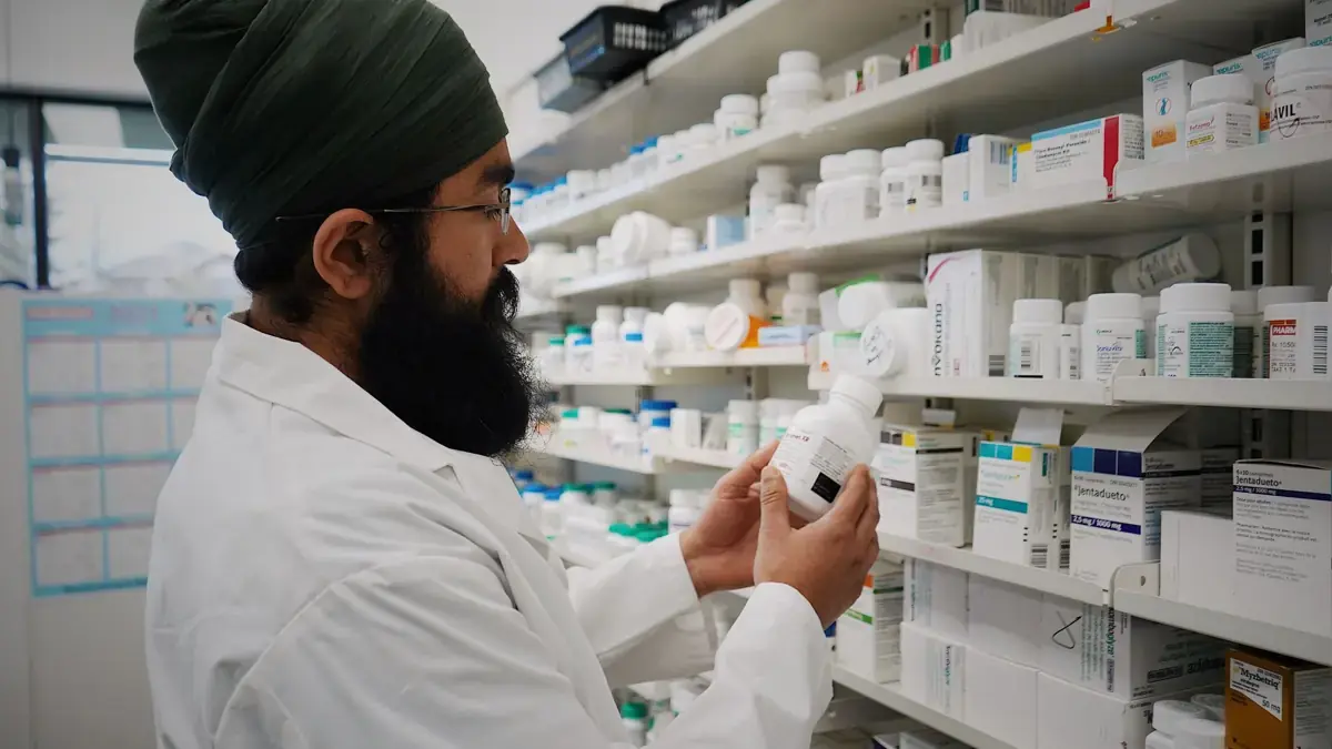 Photo: Pharmacist with turban organizing shelves in a pharmacy, focused on healthcare.
