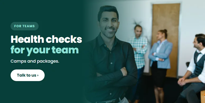 A smiling colleague at an Indian office. Health checks for your team.