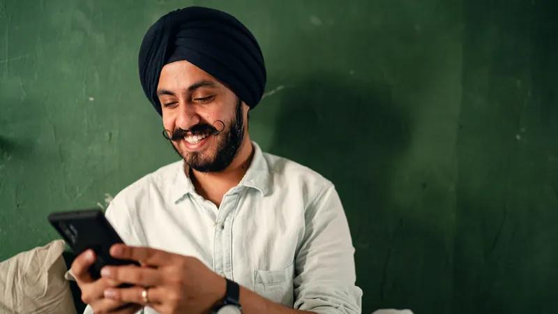 Illustrative scene: a man smiling at his phone
