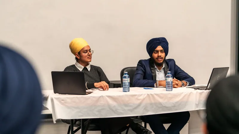 Illustrative scene: two professionals presenting at a conference table