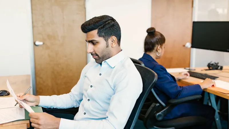 Illustrative scene: two professionals collaborating in a modern office