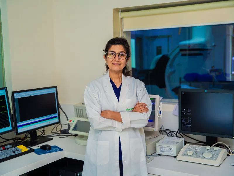 Illustrative scene: a woman doctor in a white coat standing in a diagnostic room