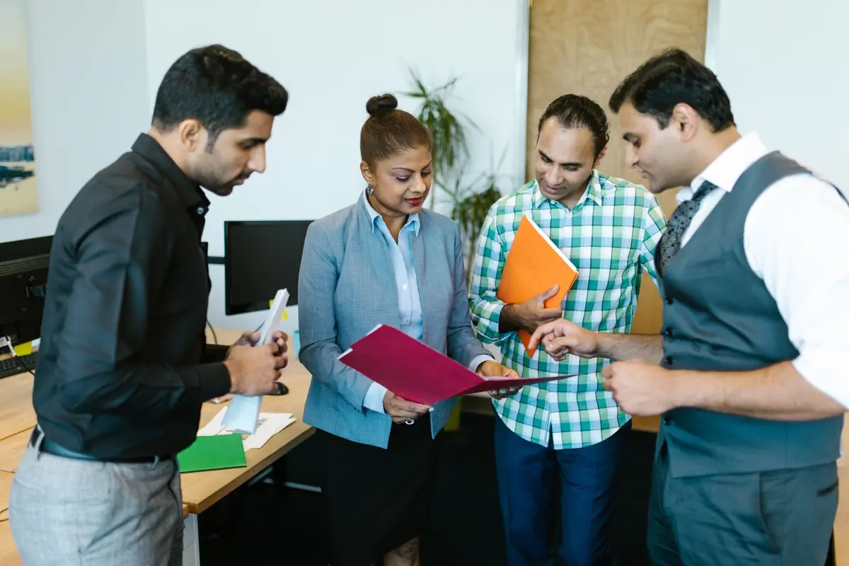 Colleagues in a meeting room at an Indian office, illustrative scene